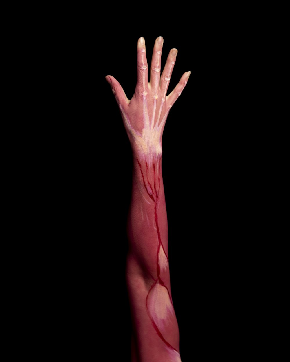 persons left hand with pink paint