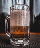 Close-up of a frosty beer mug with condensation on the glass.