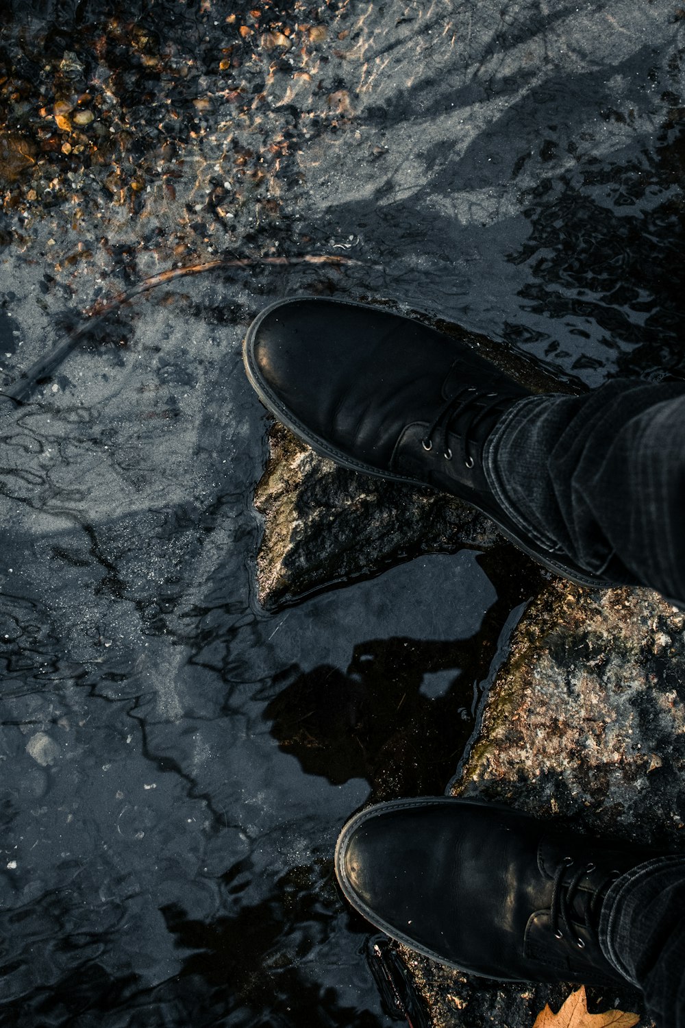 person in black pants and black leather shoe