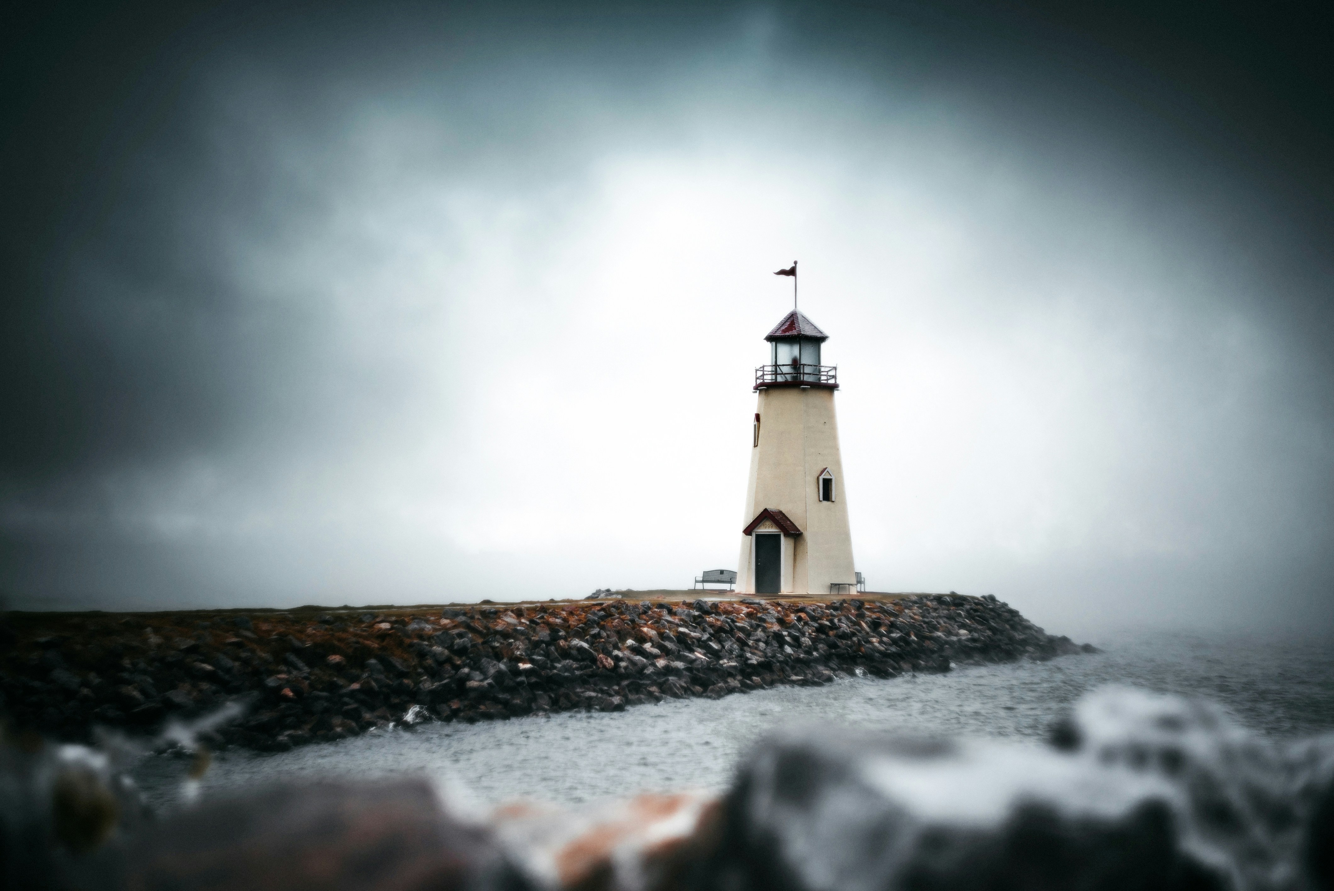 white-and-black-lighthouse-under-gray-sky