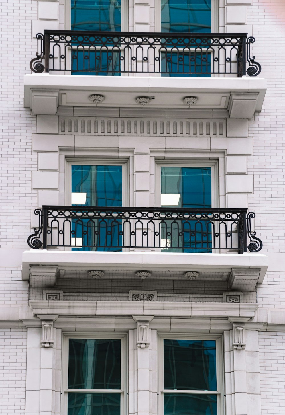 black metal gate on white concrete building