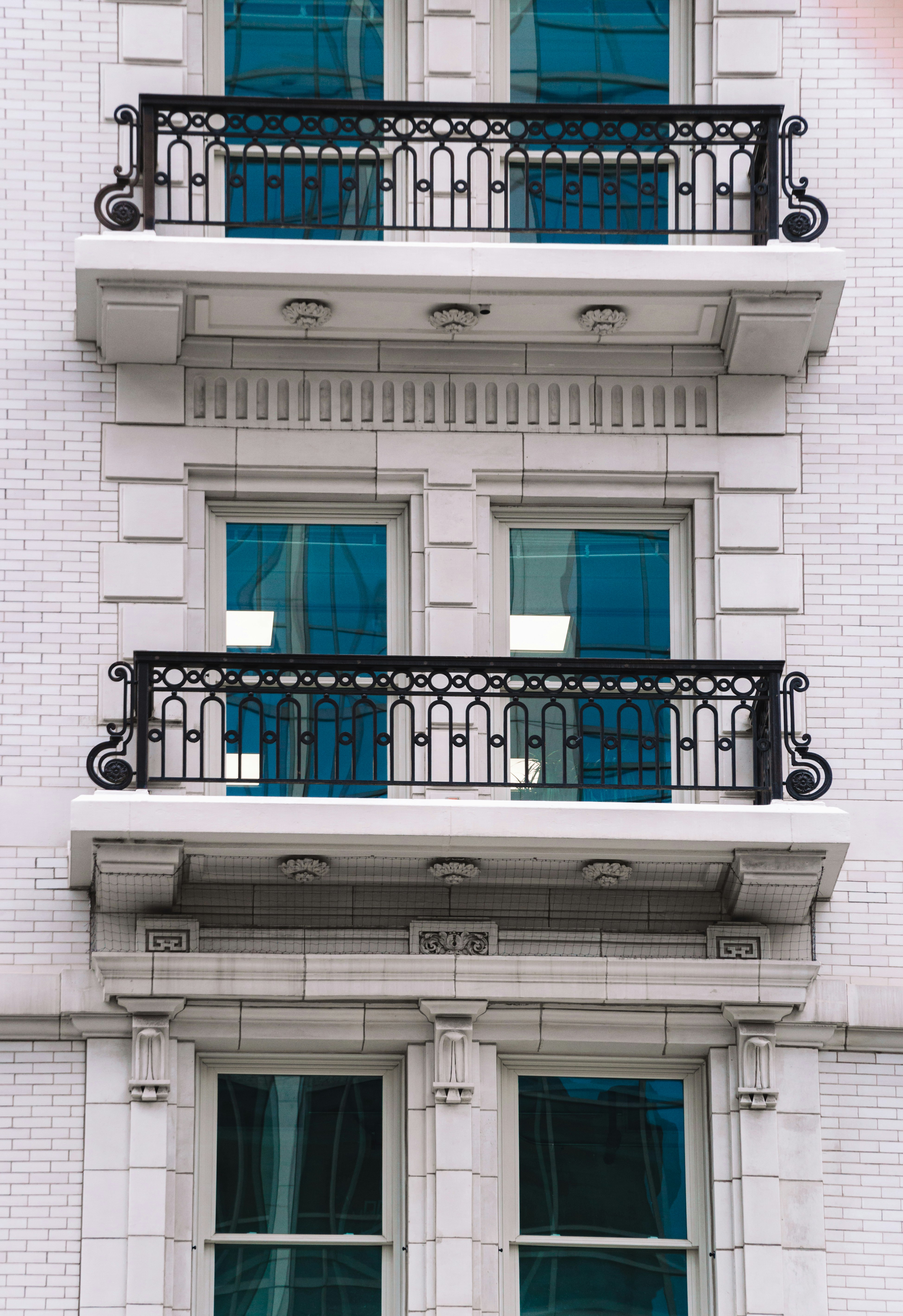 black metal gate on white concrete building