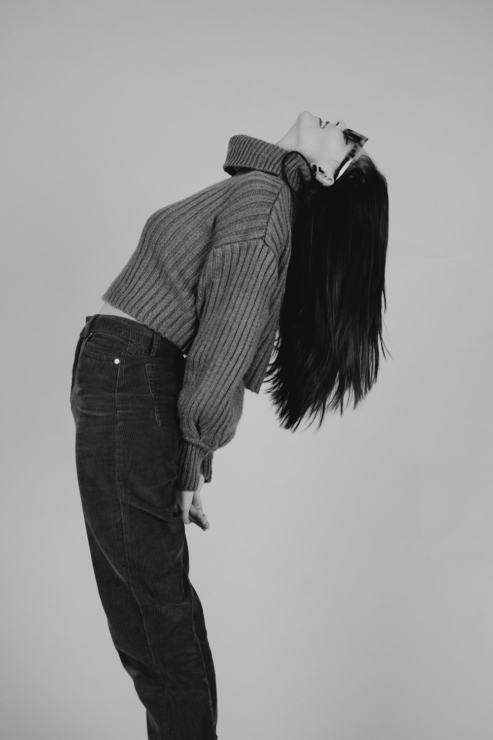 woman in black and white striped long sleeve shirt and blue denim jeans