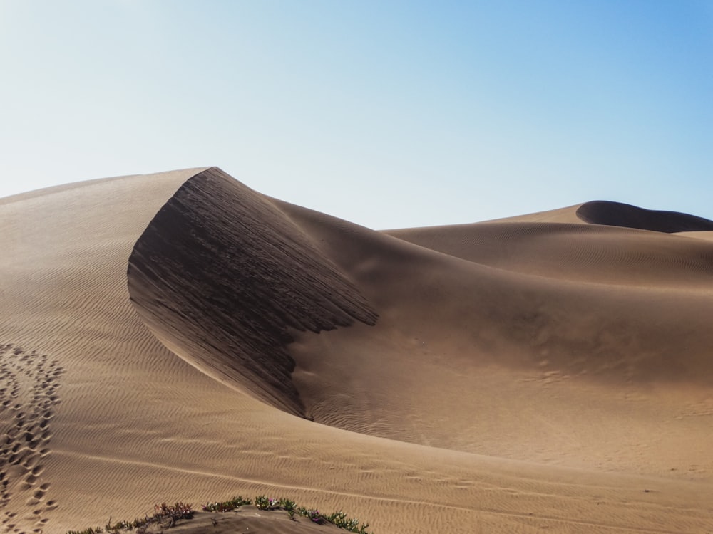 brown sand under blue sky during daytime