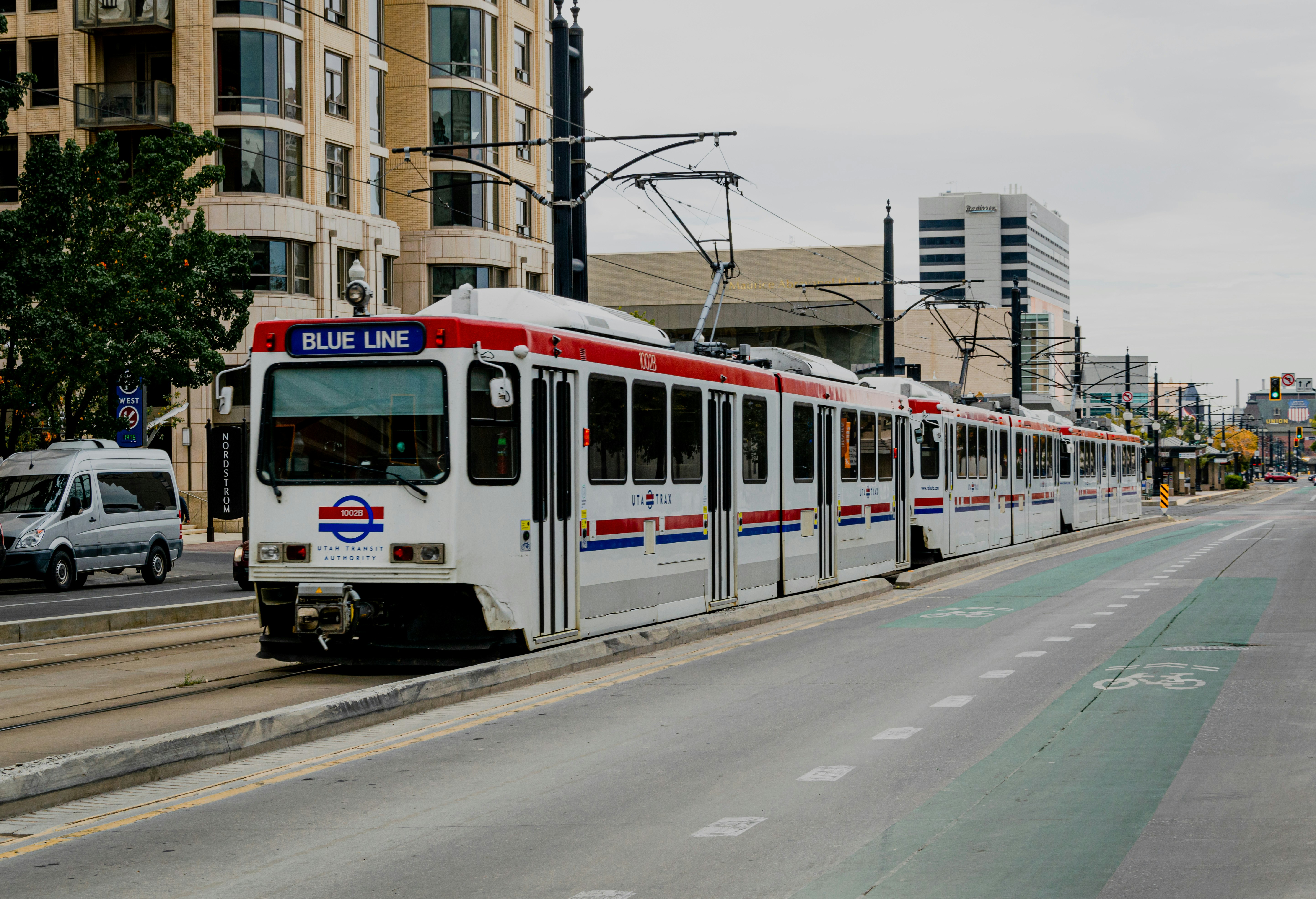 white and red tram on road during daytime