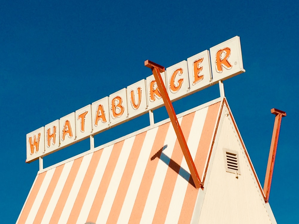 white and brown wooden signage