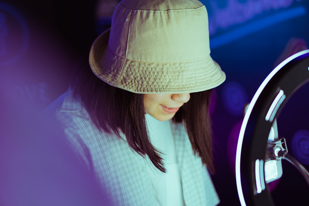 woman in white and black striped shirt wearing brown hat