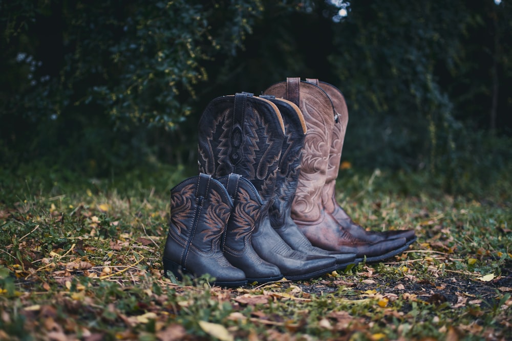 black and brown leather cowboy boots on green grass