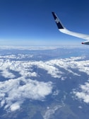 A panoramic view of a mountain range from a small aircraft.