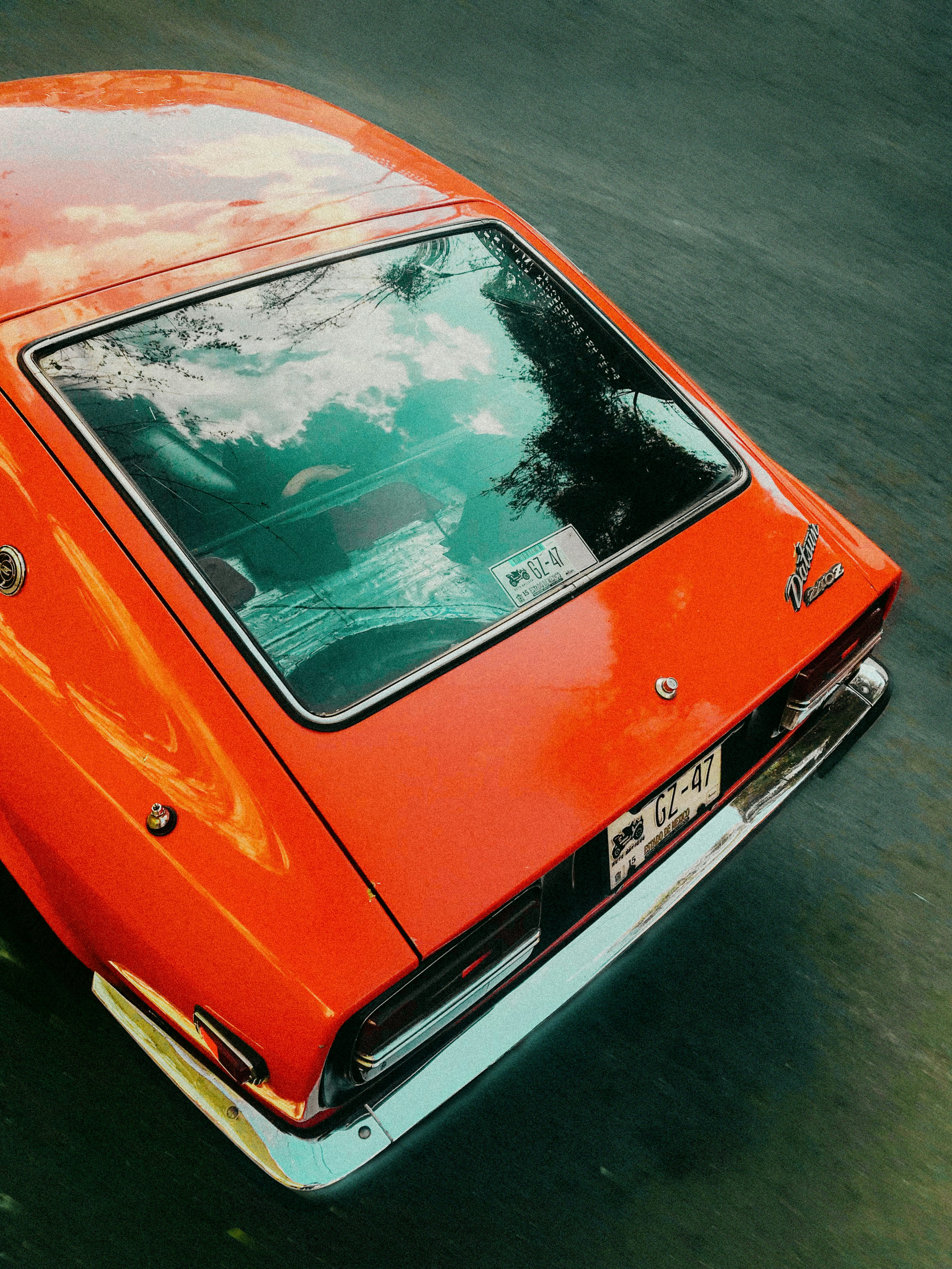 red car on gray asphalt road