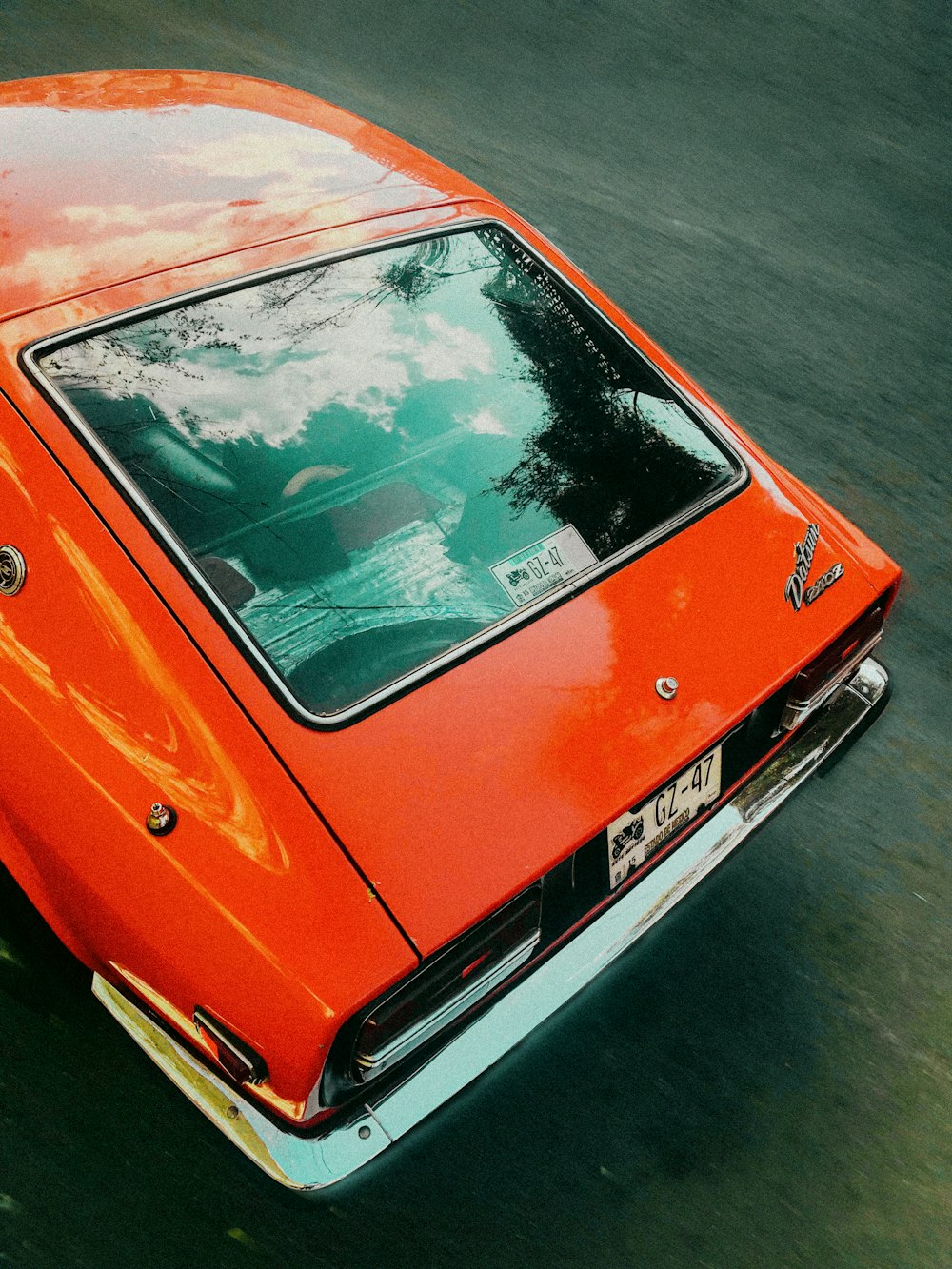 red car on gray asphalt road