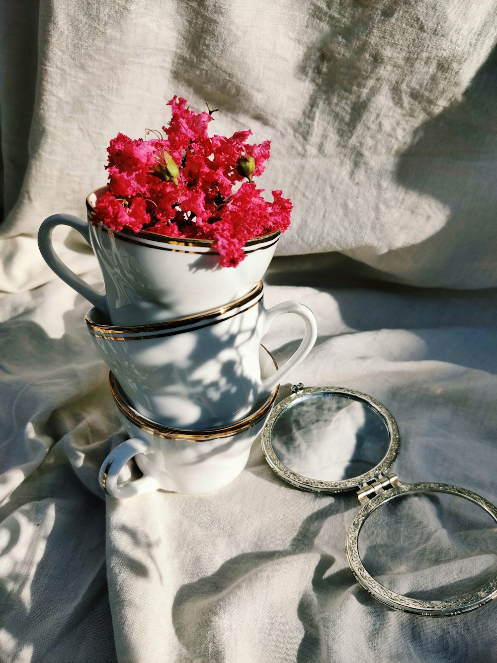 white and red floral ceramic teacup with saucer