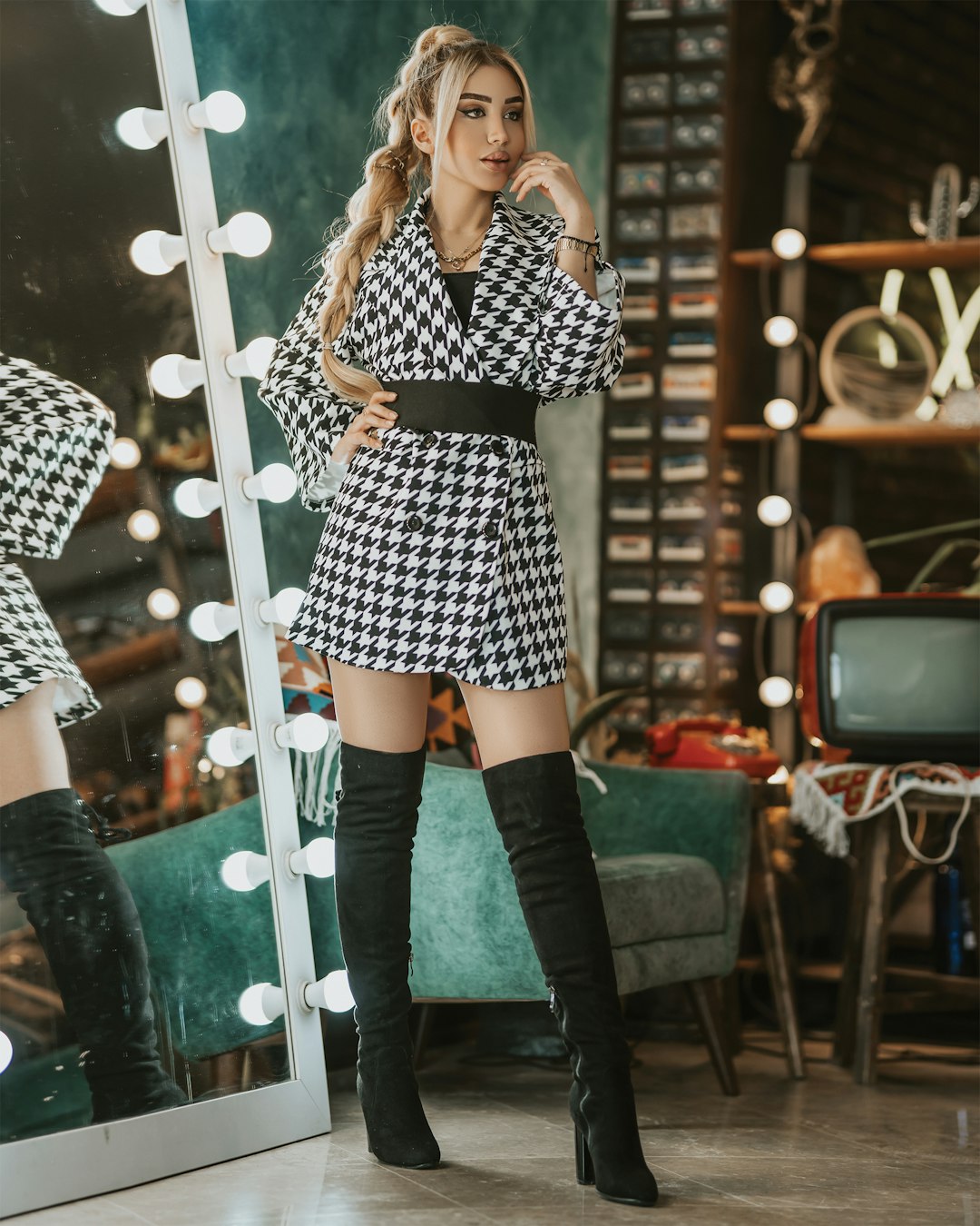 woman in black and white long sleeve mini dress and black knee high boots