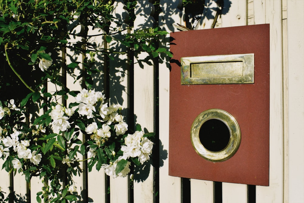 Fiori bianchi sulla porta di legno rossa e bianca