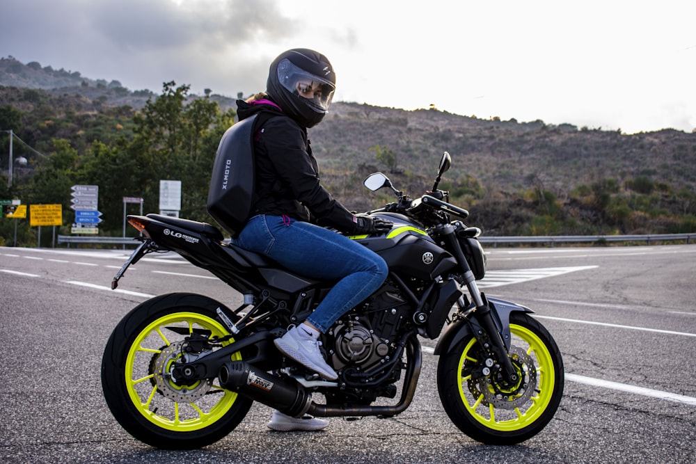 man in black jacket riding on black and gray motorcycle during daytime