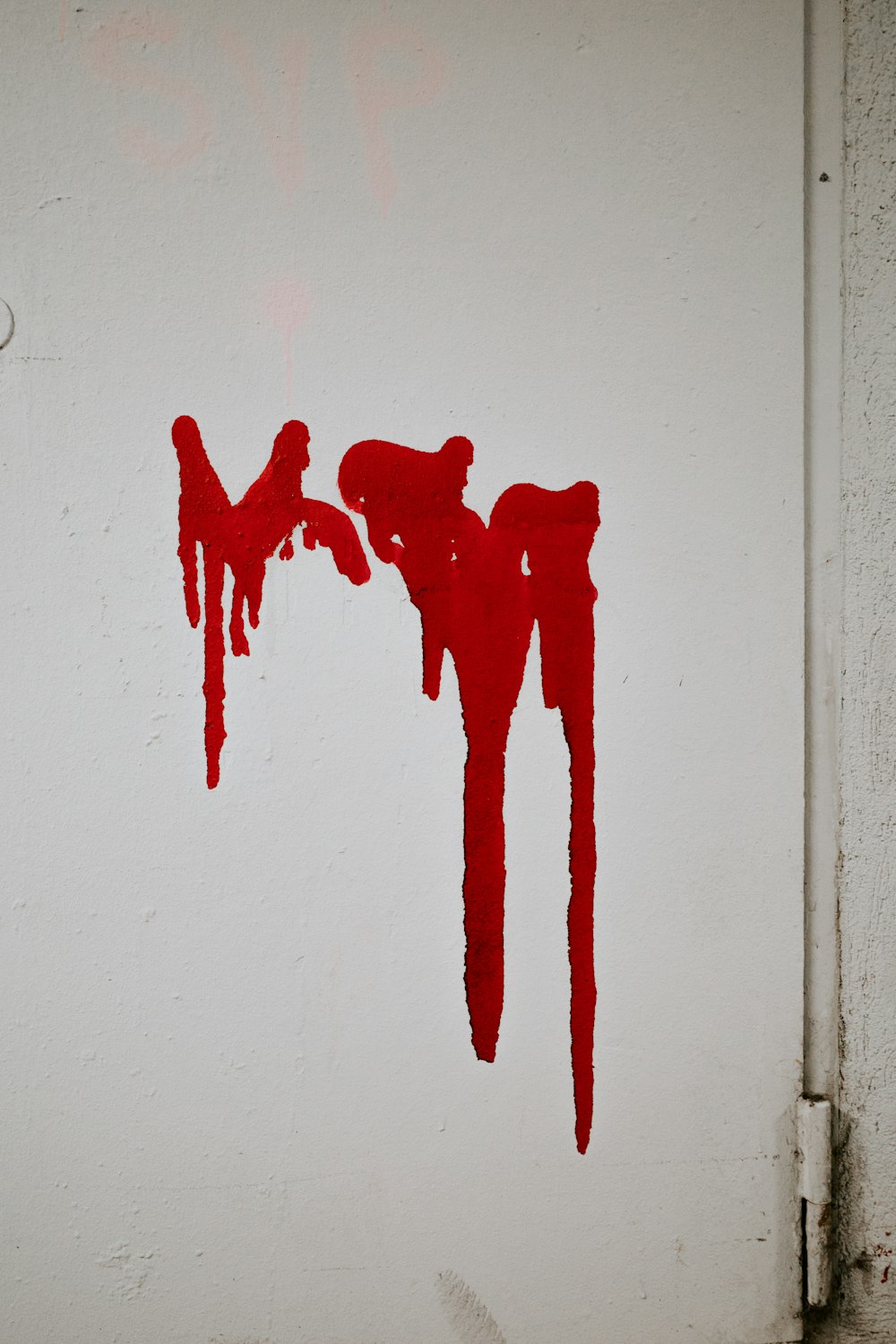 red hand sign on white wall
