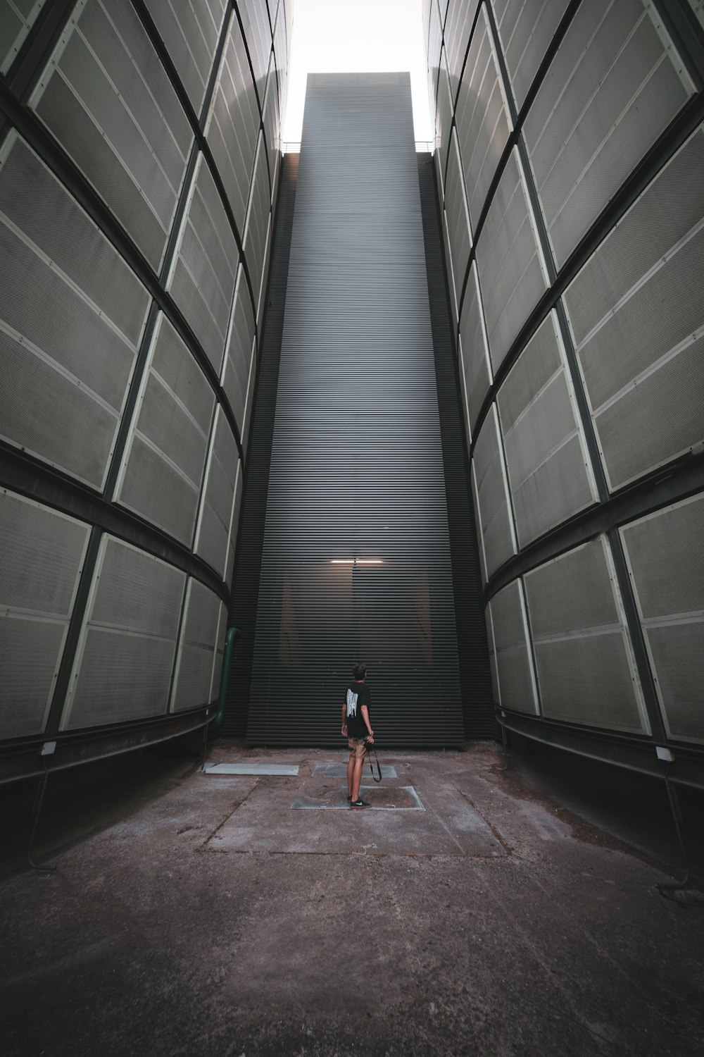 woman in orange dress walking on brown wooden floor