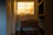 A cozy room softly lit by a solar desk lamp on a wooden table.