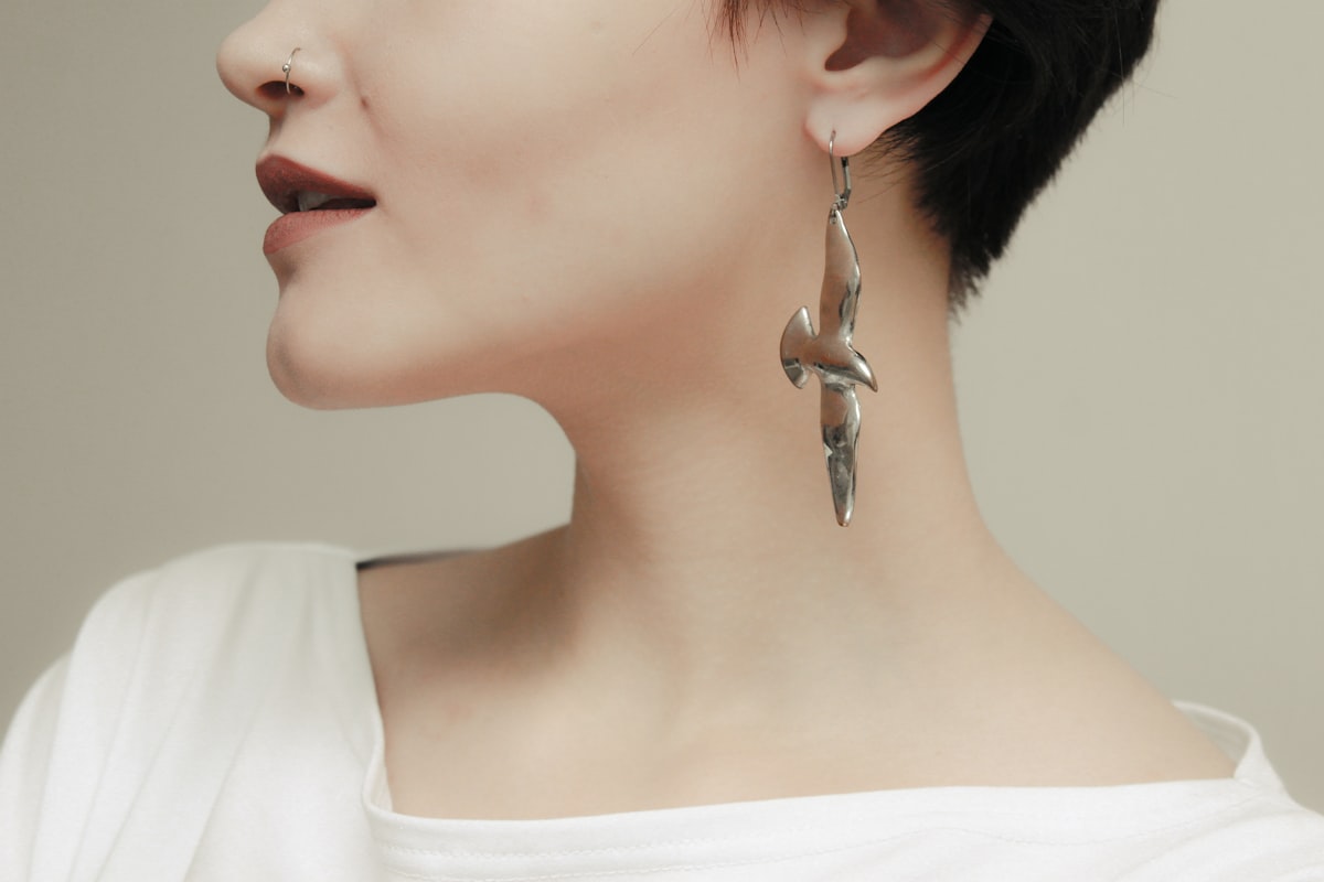 Woman wearing silver earrings demonstrating hypoallergenic jewelry suitable for sensitive skin and nickel-free options