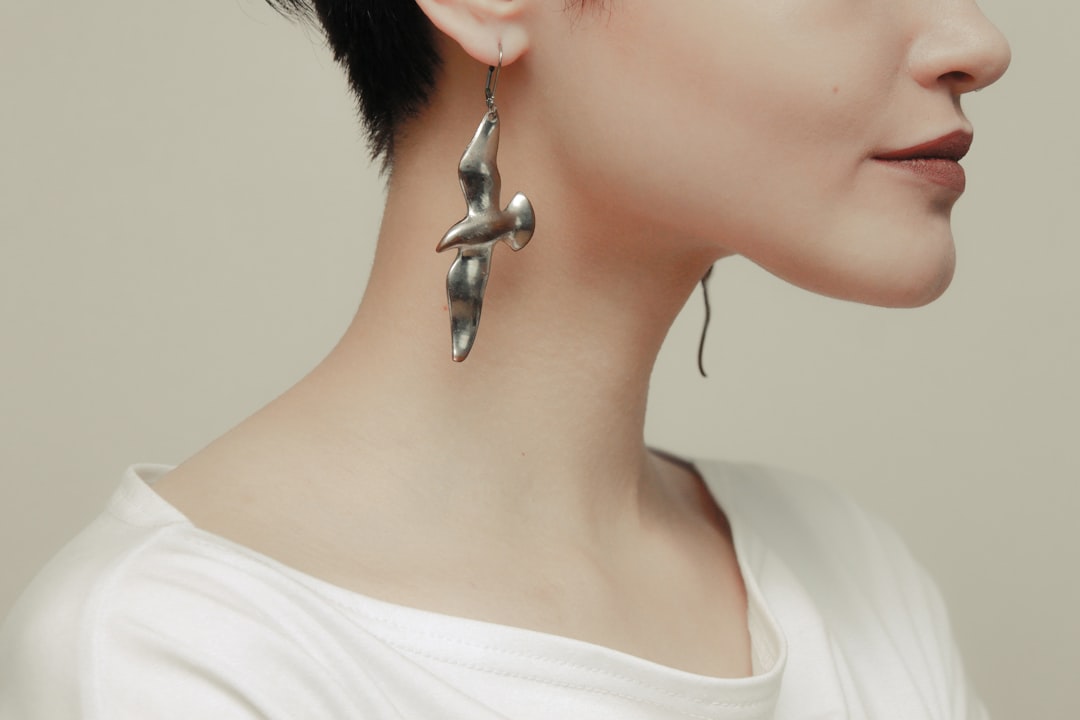 woman in white shirt with silver stud earring