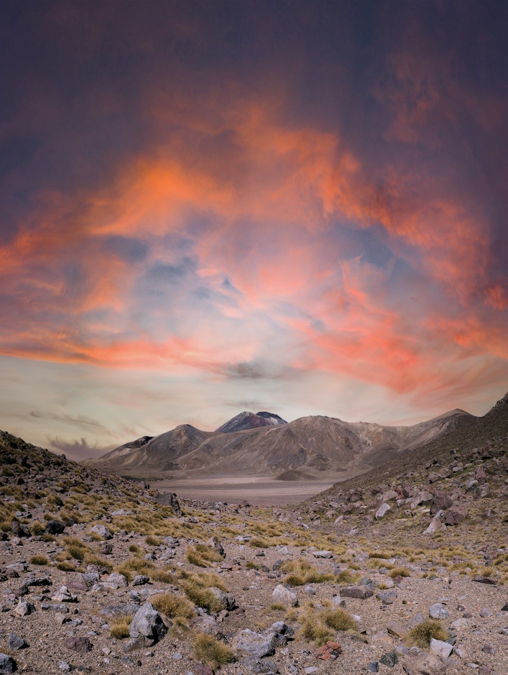 snow covered mountain under orange and blue sky