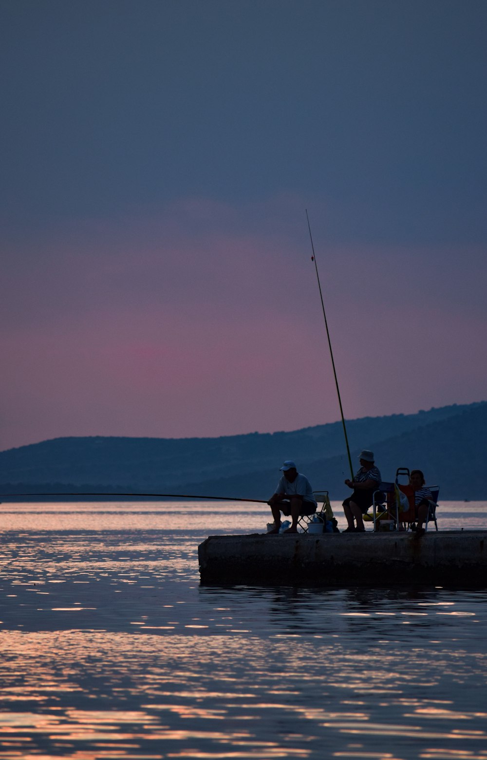 people fishing on sea during daytime