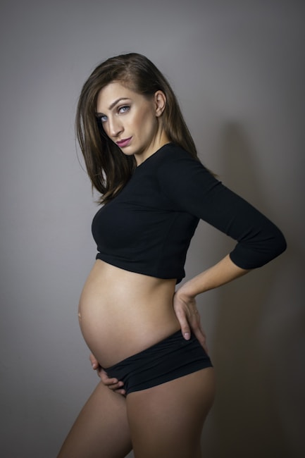 woman in black long sleeve crop top and black bottoms