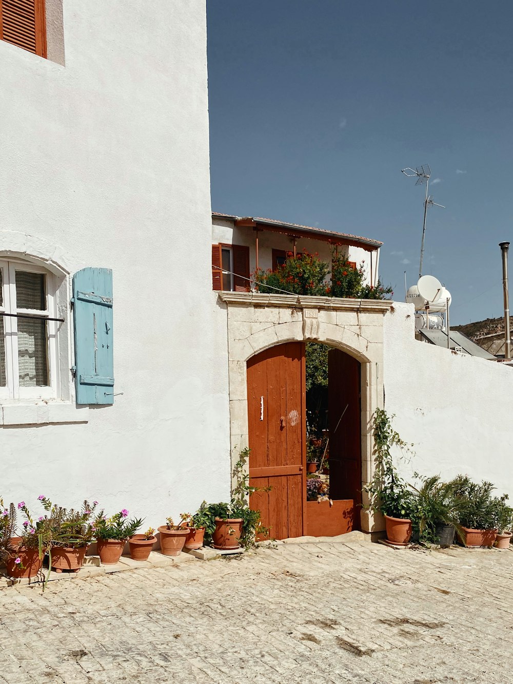 brown wooden door on white concrete building