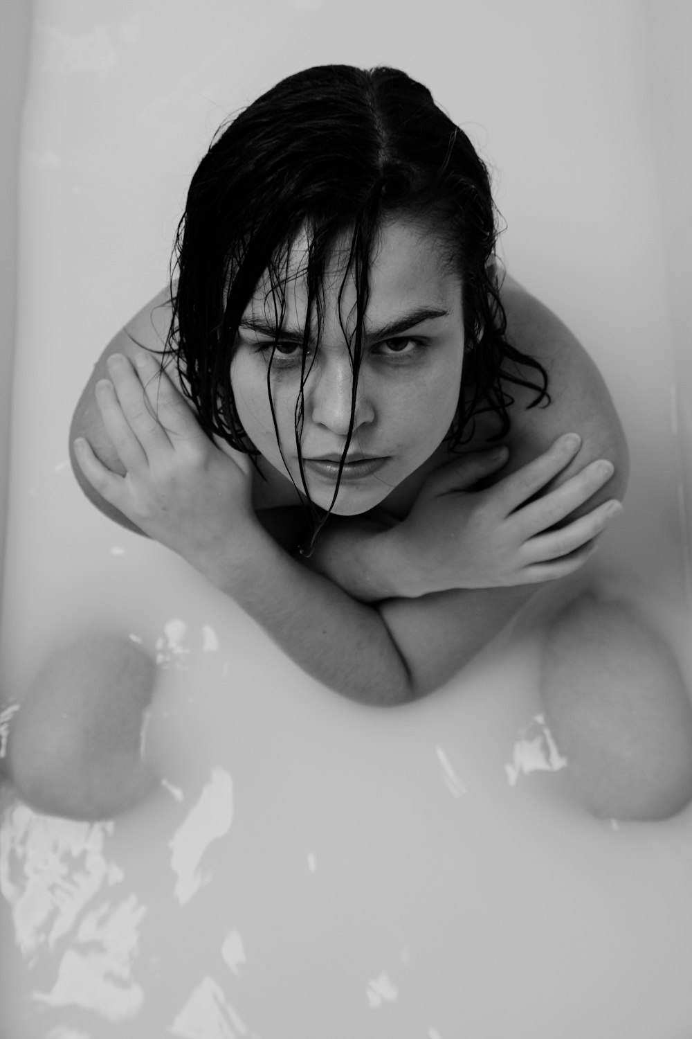 grayscale photo of woman in bathtub