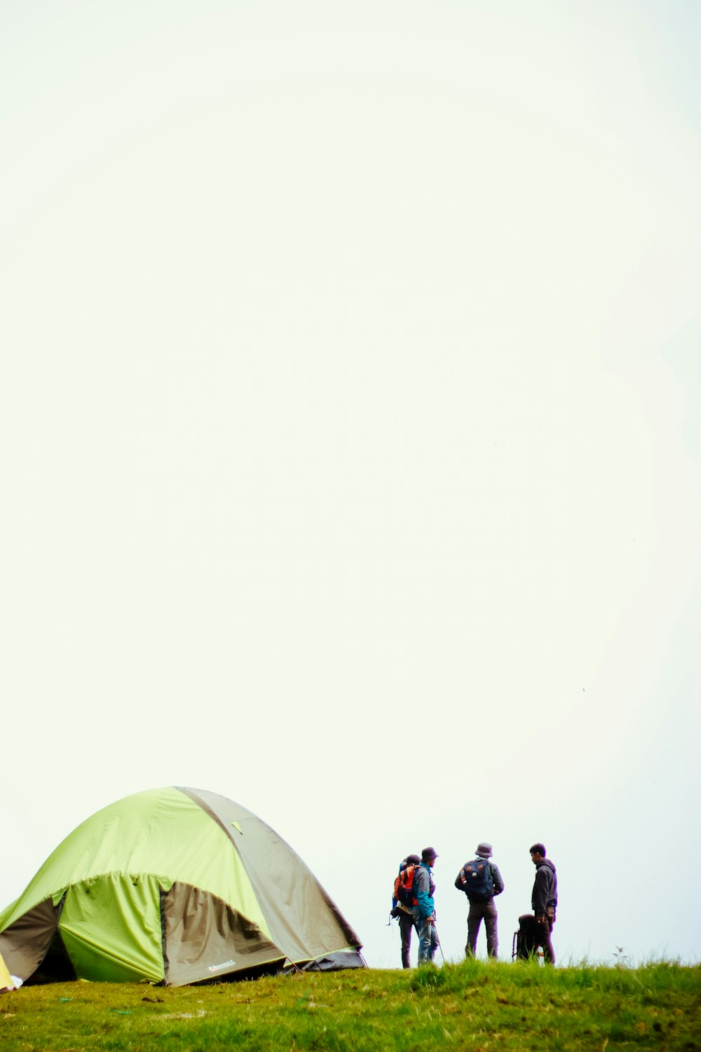 green and white tent with people walking on the street