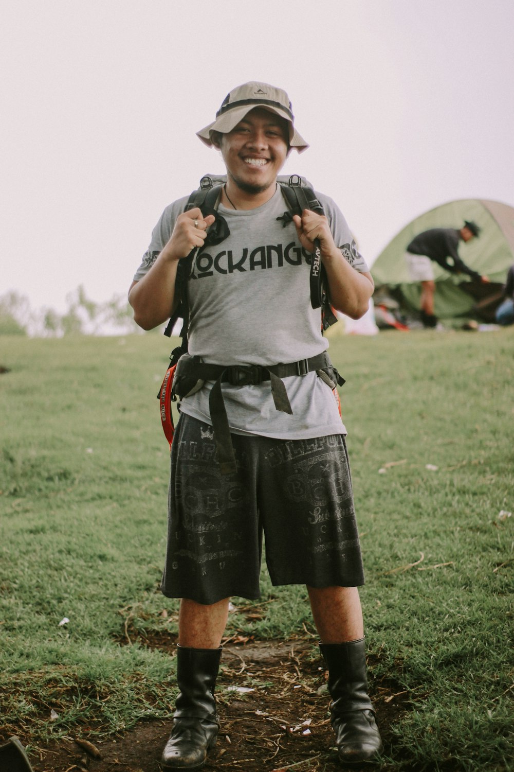 man in black crew neck t-shirt and black shorts standing on green grass field during