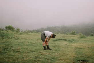 man in gray t-shirt and black shorts playing golf during daytime