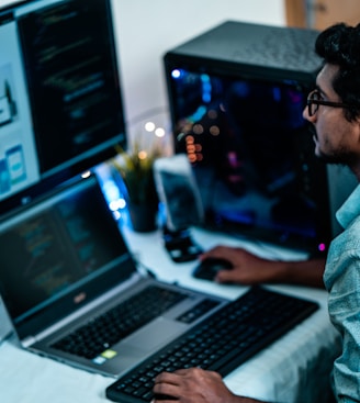 man in blue dress shirt using computer