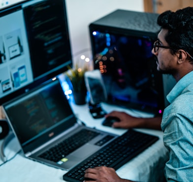 man in blue dress shirt using computer