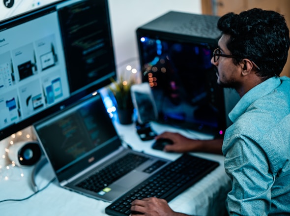 man in blue dress shirt using computer