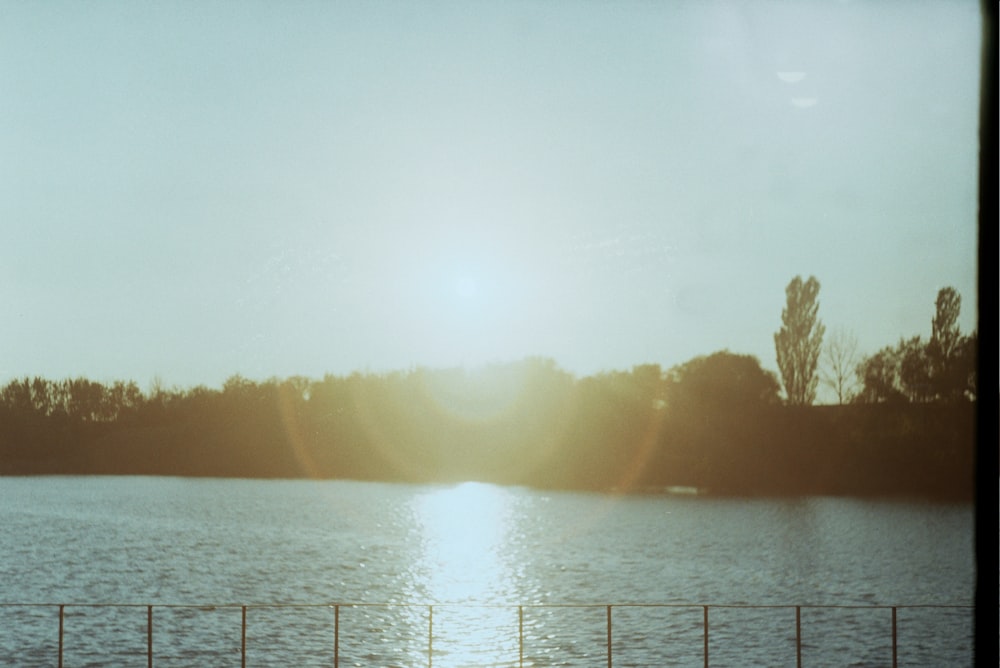 body of water near mountain during daytime