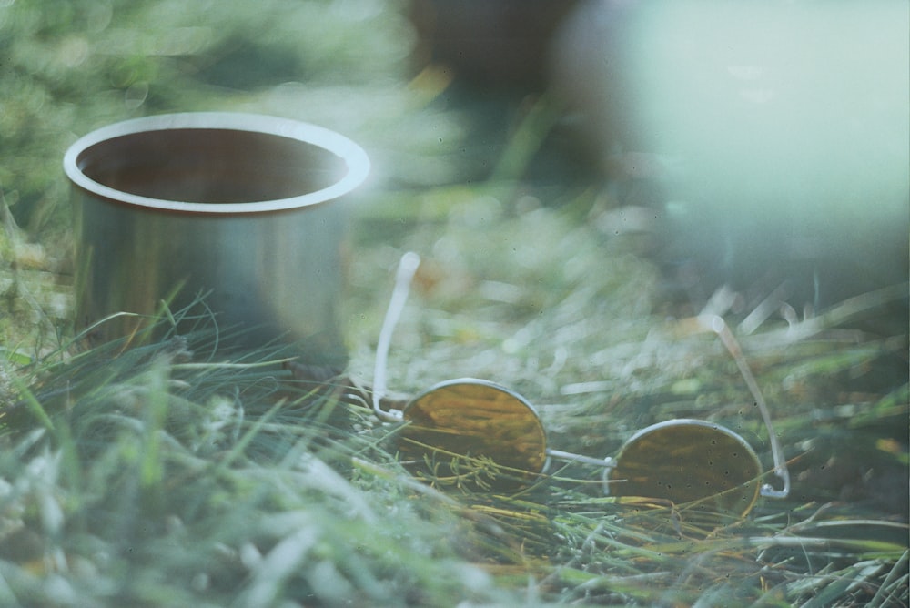 silver round cup on green grass