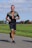 A man jogging in a park, enjoying his fitness journey.