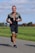 A happy customer running outdoors after a successful training session.