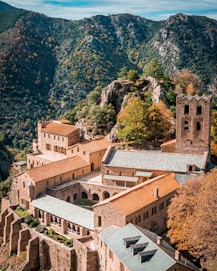 brown concrete building near green trees during daytime