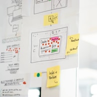 Flowcharts and templates laid out on a desk to map organizational processes.