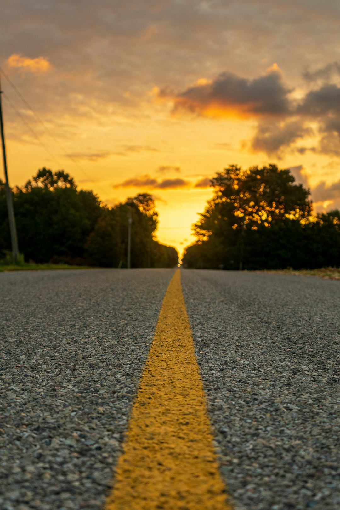 grey concrete road with yellow line