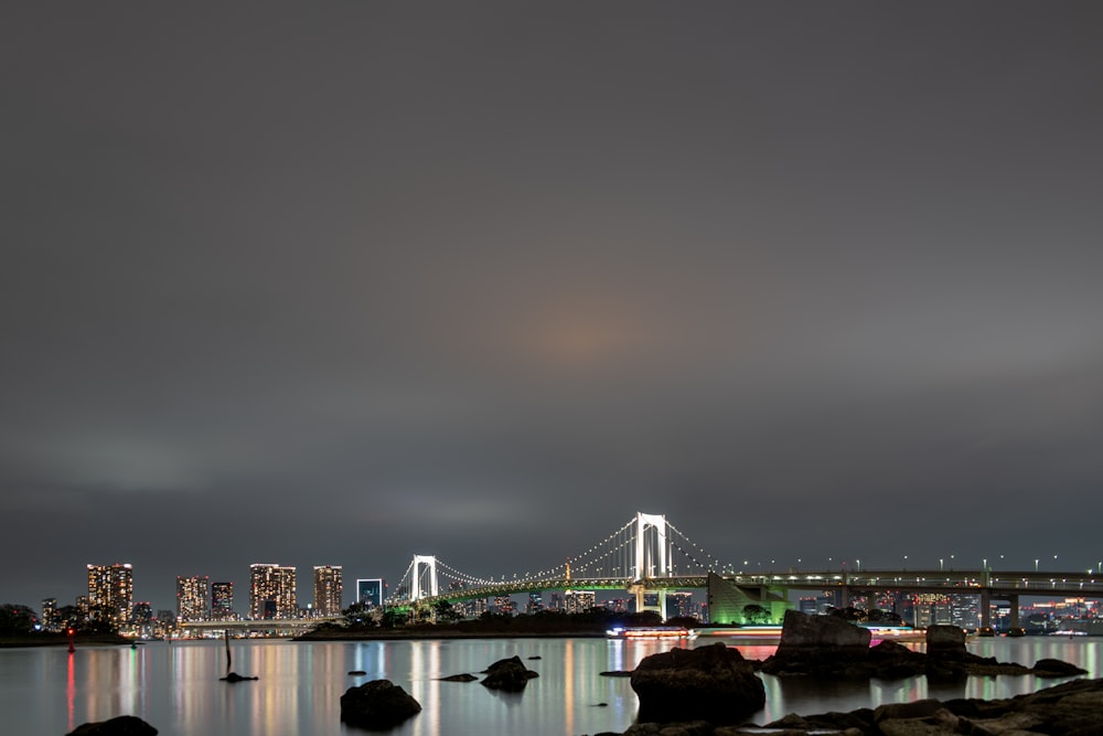 bridge over body of water during night time