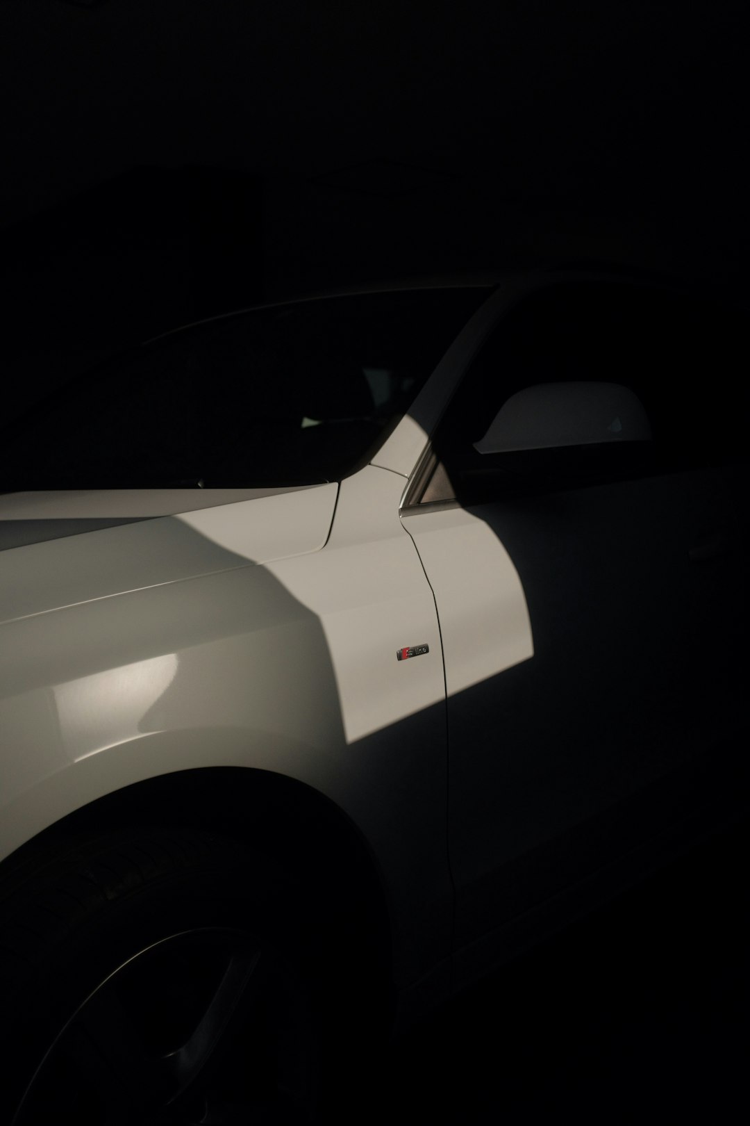 white car in dark room