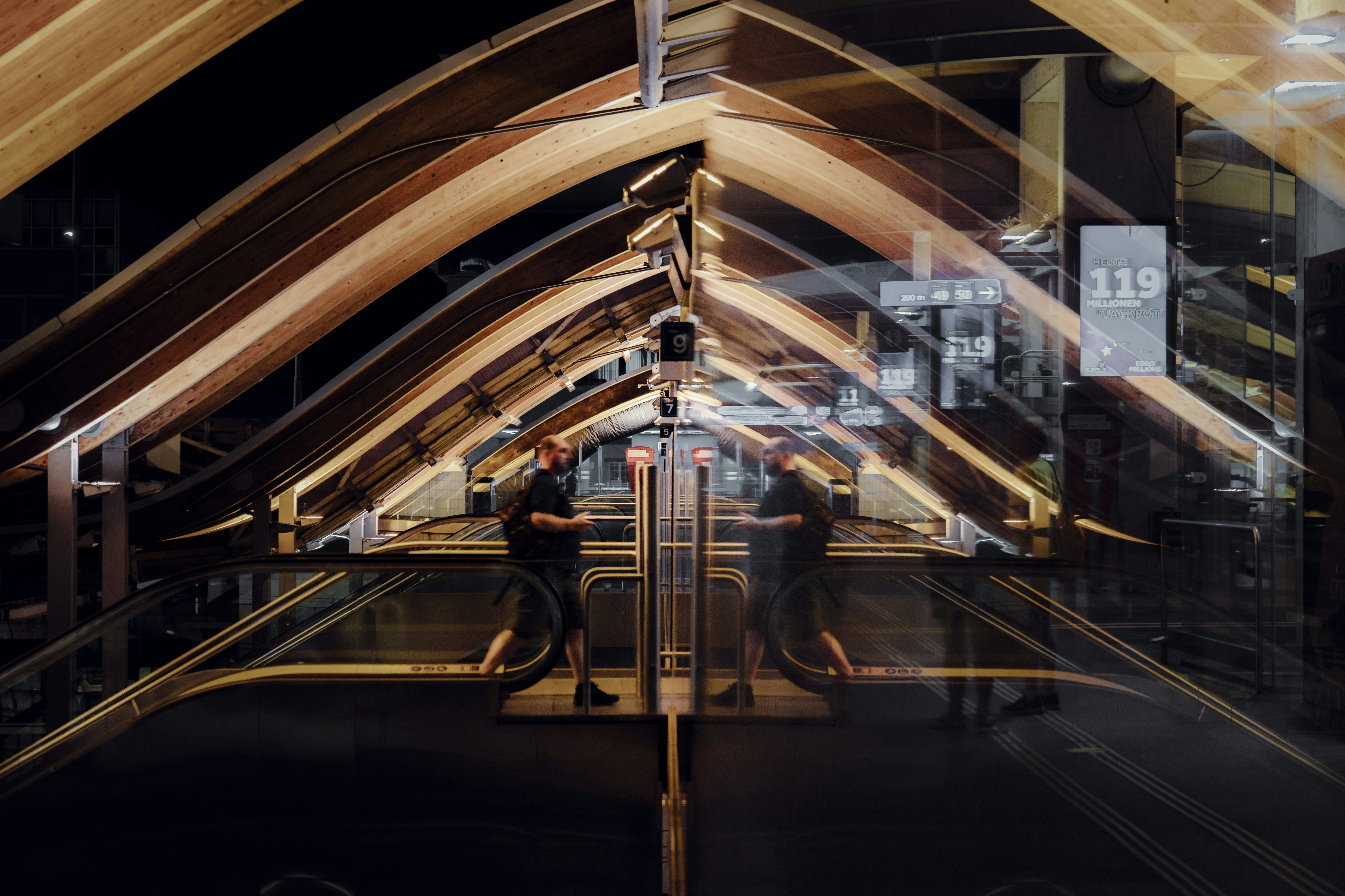 people walking on sidewalk during night time