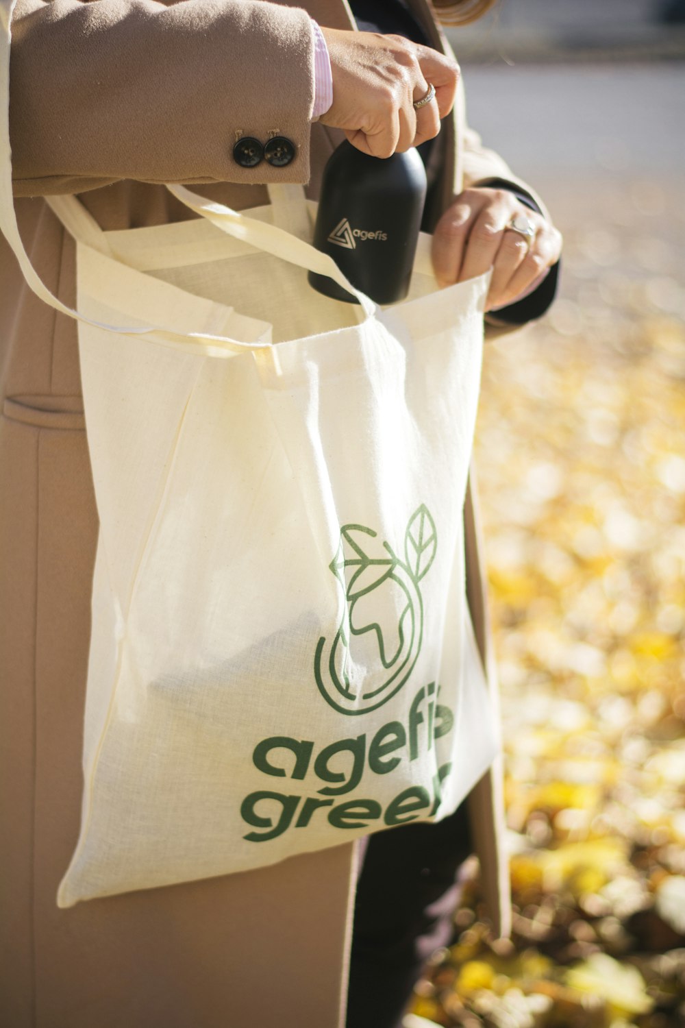 person holding white plastic bag