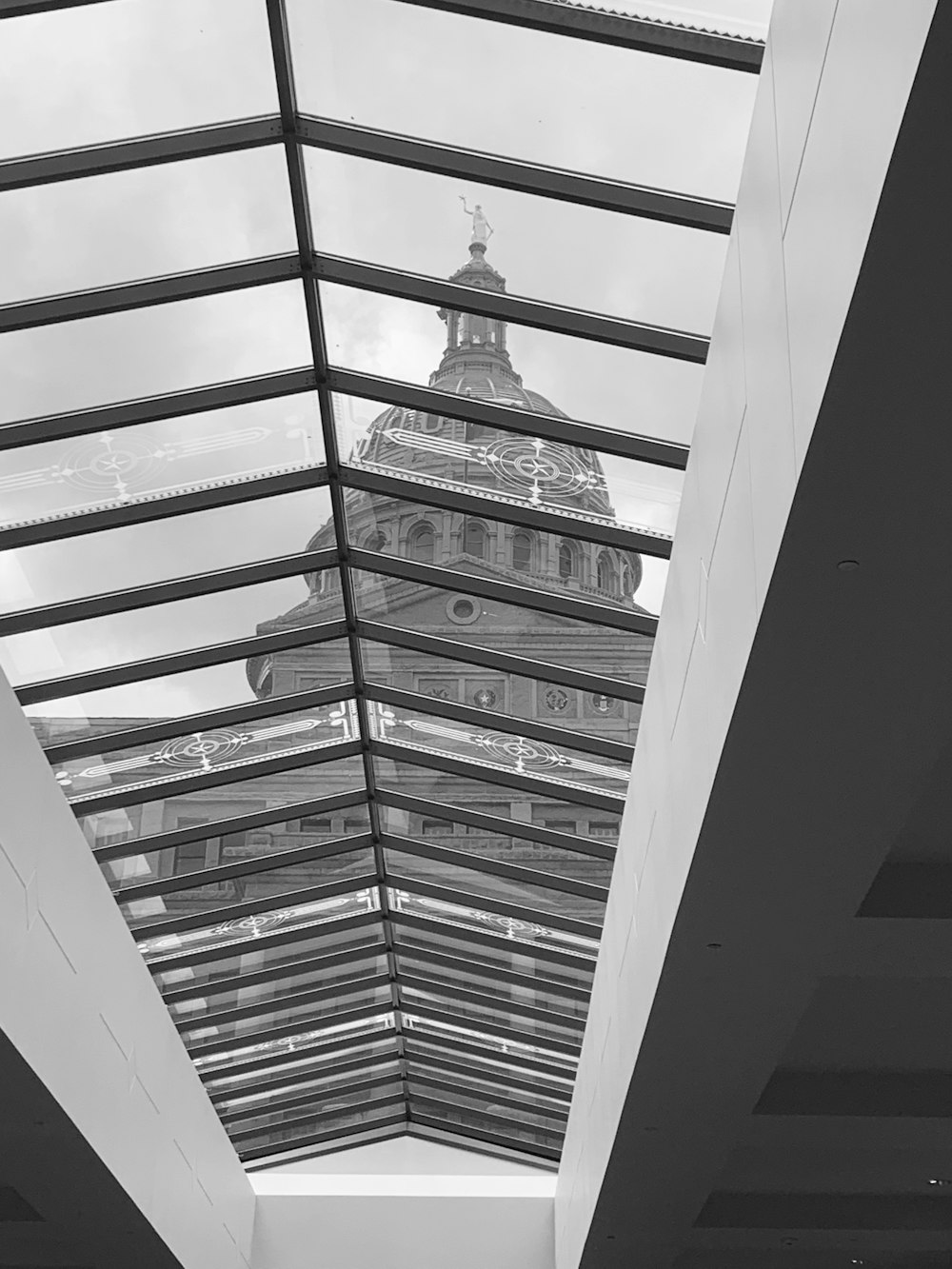 grayscale photo of a man in a building
