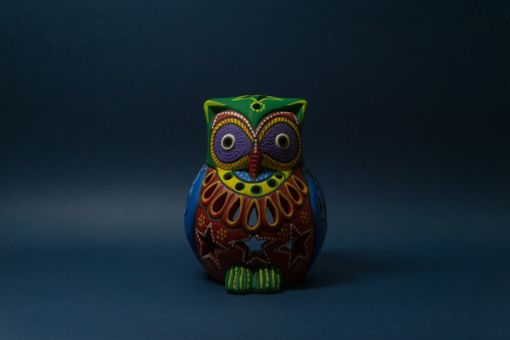 yellow green and blue owl ceramic figurine