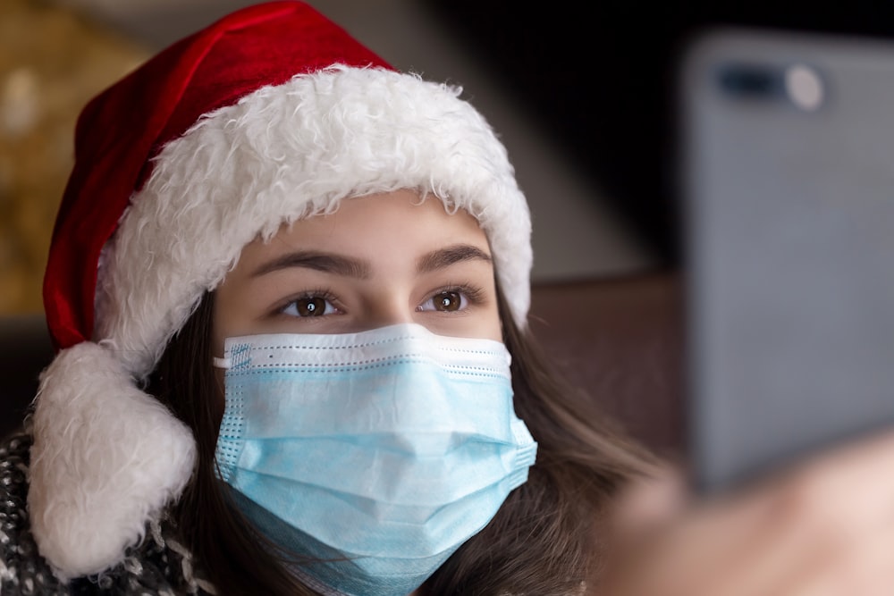 woman in white and red santa hat