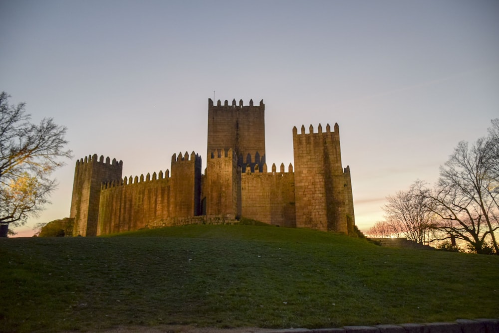 brown concrete castle under gray sky